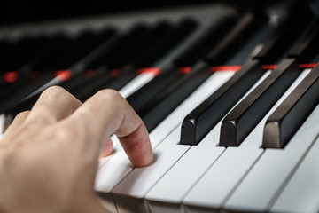 Fototapeta na wymiar Piano keys on black classical grand piano - closeup for music production and recording
