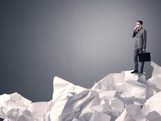 Businessman standing on crumpled paper