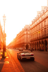 Fototapeta na wymiar Paris street and super car at sunset