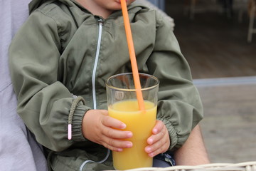 Child drinking orange juice