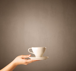 Female hand holding coffee cup