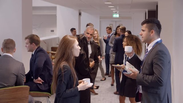 Delegates Networking During Coffee Break At Conference