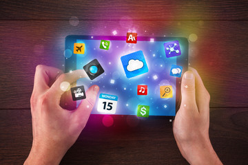 hands holding tablet