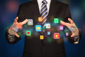 Businessman holding application icons