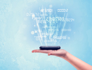 Hand holding phone with digital numbers