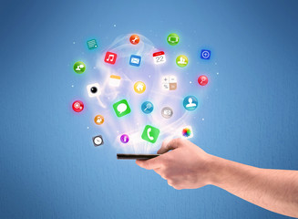Hand holding tablet phone with app icons