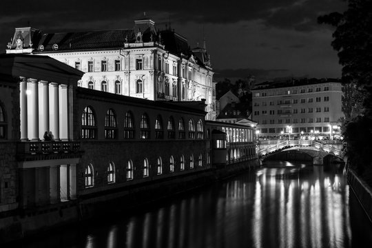 Central streets of Ljubljana Slovenia at night water channel window lights reflected in water beautiful architect  