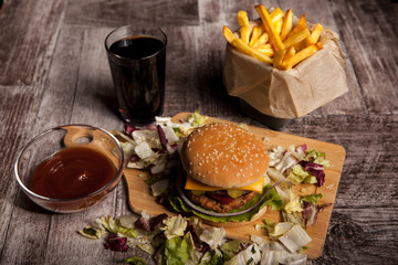 Over top view of Delicious tasty burgers on wooden background. Fast and tasty food