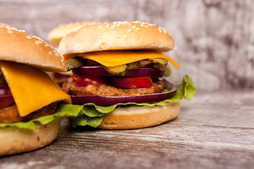 Close up of Delicious tasty burgers on wooden background. Fast and tasty food