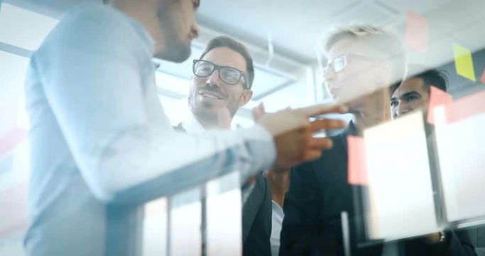 Picture of designers sticking notes in office