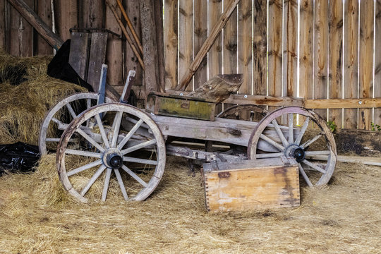 wooden barn is beautiful and the old horse cart