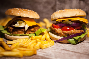 Fresh Delicious tasty burgers on wooden background. Fast and tasty food