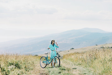 Woman walking with bicycle outdoor.
