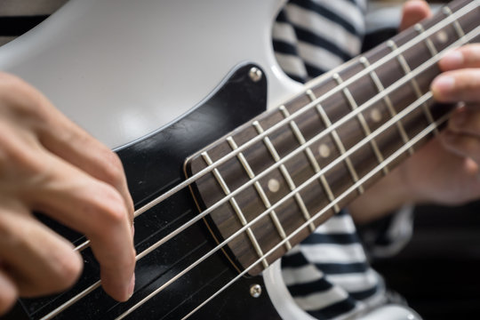 bass guitar finger style closeup - musical instruments - concept musical composition and creativity