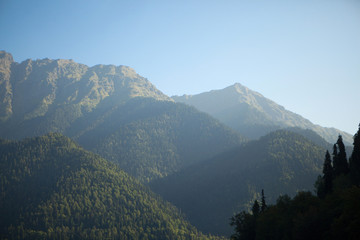 Obraz premium beautiful high mountains with a green summer landscape in clear sunny weather with a blue sky
