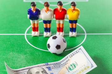 Table football .soccer players ball and dollars on the field.bookmaker concept