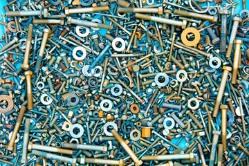Abstract grunge metallic background from bolts, screws, nuts