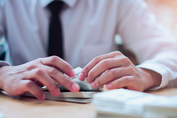 Businessman counting U.S. dollar bills.