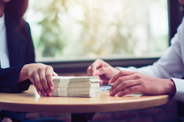 Hand giving money - United States Dollars (or USD)