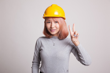 Asian engineer woman show Victory sign.