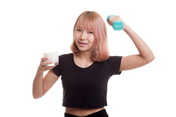 Healthy Asian woman drinking a glass of milk and dumbbell.