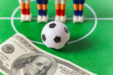 Table football .soccer players ball and dollars on the field.bookmaker concept