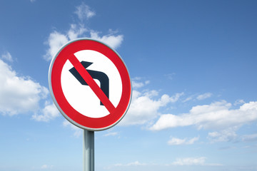 No Right Turn road sign, against a background of a bright blue summer sky.