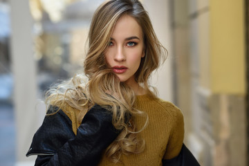 Beautiful blonde russian woman in urban background