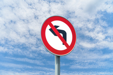 No Right Turn road sign, against a background of a bright blue summer sky.