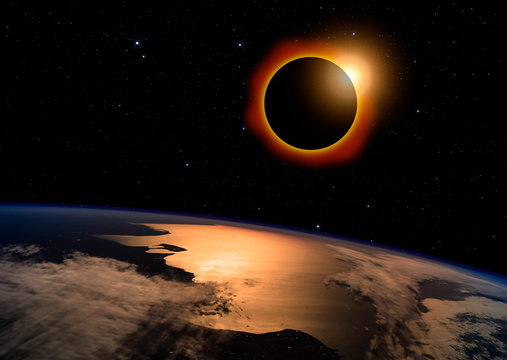 Solar eclipse with orange halo over the planet Earth, on dark starry sky