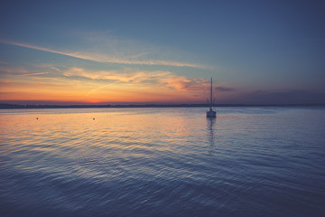 Yacht in the sea at sunset