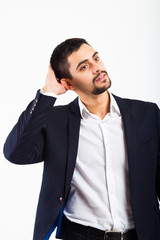 A man in a business suit, on a white background, in a reverie scratches his head, touches his hair. Pleasant appearance.