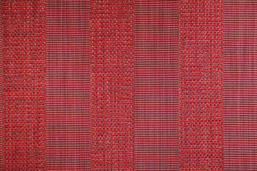 Texture of textile rug with striped pattern of red colors