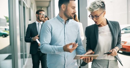 Young designers talking on break about business plans - Powered by Adobe