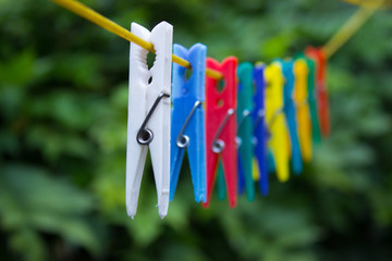 Colorful clothespins hanging on a clothesline