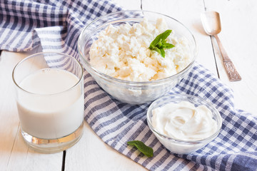 Dairy products in glass dishes on White wood