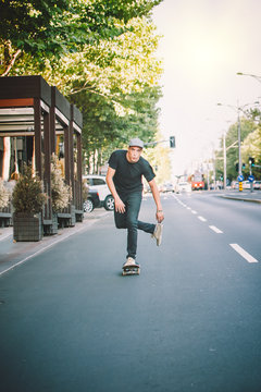 Pro skateboarder ride skateboard on capital road street through traffic