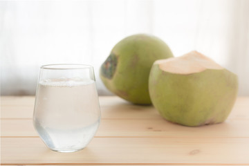 a glass of coconut water on wooden table