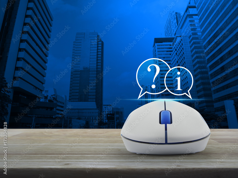 Poster question mark and information chat icon with wireless computer mouse on wooden table over modern off