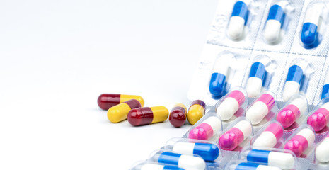Colorful of antibiotic capsules pills on white background, drug resistance with copy space