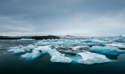 Melting ice on the water in Jokulsarlon lake in south Iceland in cloudy day. Global waming