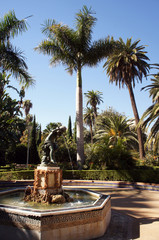 Fountain sourounded by palms inParque de la Alameda (Malaga, Spain)