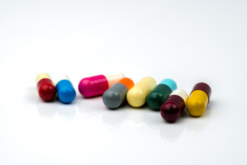 Colorful of antibiotic capsules pills on white background with copy space. Drug resistance, antibiotic drug use with reasonable, health policy and health insurance concept.