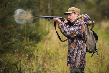 Fototapeta premium The hunter shoots from the hunting rifle. 