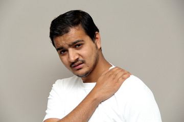 Fototapeta premium pain in neck, man in pain, expressions of young amazed man isolated on gray background