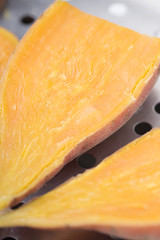 Closeup of cooked sliced and halved sweet potatoes.