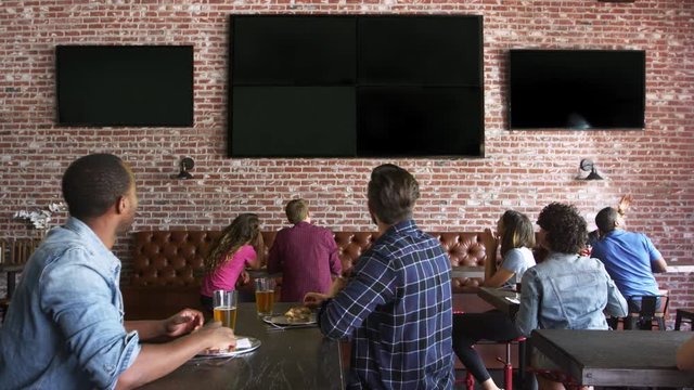 Friends Watching Game In Sports Bar On Screens Shot On R3D