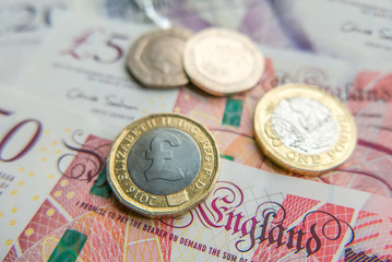 British pound notes and coins financial background close up