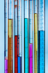 serological pipettes with colored fluid samples / background with pipettes filled with colored liquids