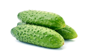 Three fresh cucumbers on white